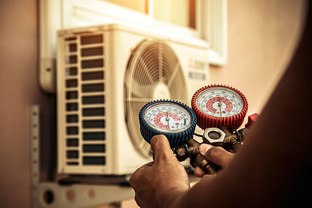 Professional Air Conditioning Service technician working in East Peoria, IL